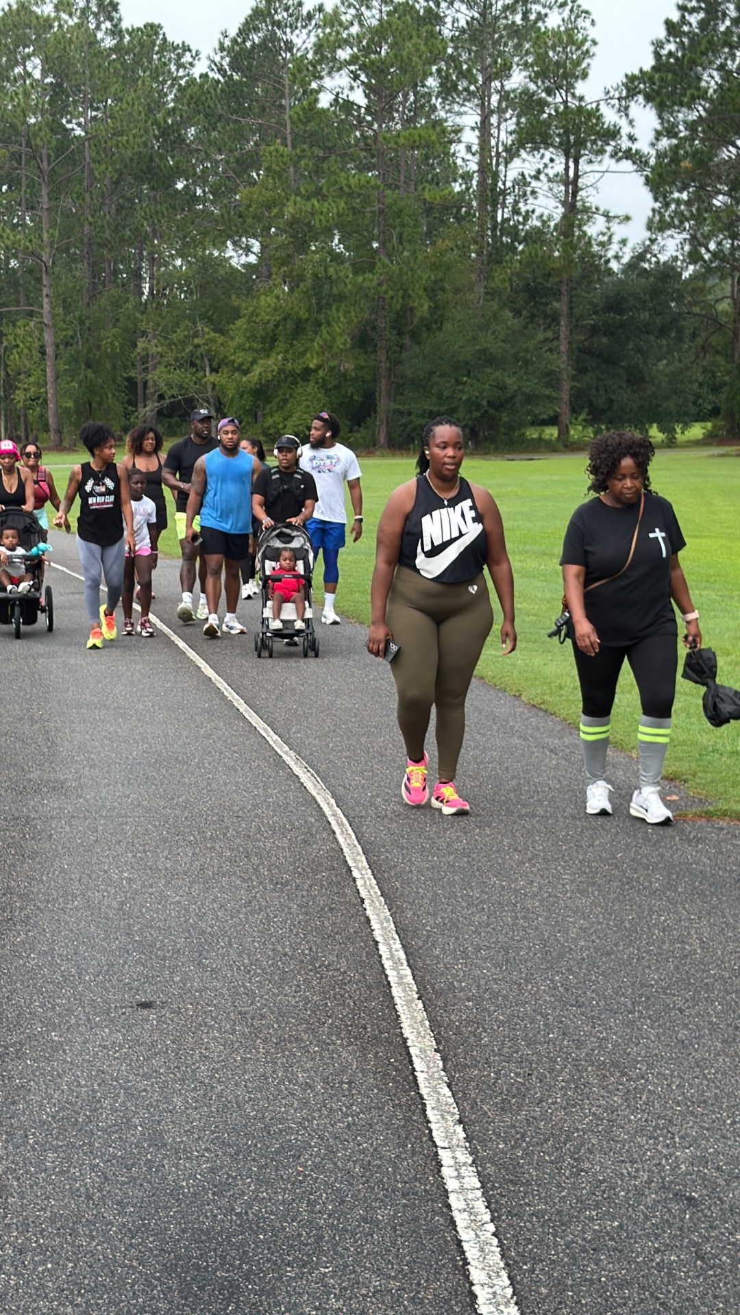 Run club members walking community miles together on the park path